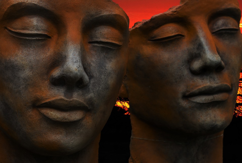 two serene statue faces
